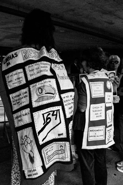 Tourists interacting with a historical reenactor near the gate