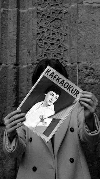 Visitors walking through the shaded, open-air corridors of the mosque complex