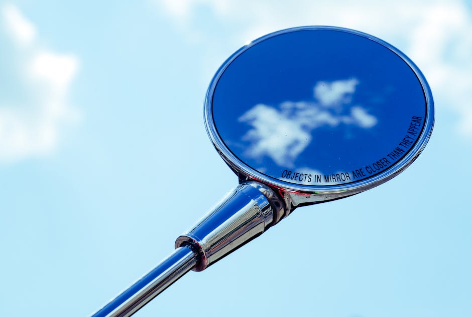 A plaza with multiple small, circular sky mirrors inset into the ground, creating a constellation of reflections